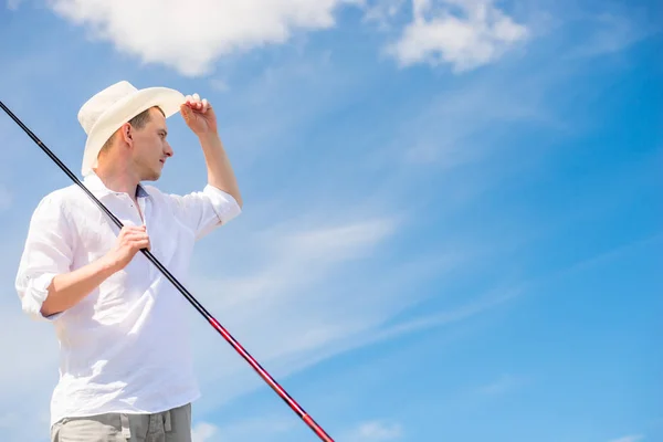 Horizontal portrait of a rural fisherman with a fishing rod in a — Stock Photo, Image