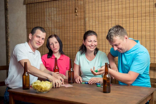 テーブルでのポーカーと飲みながら幸せな 4 人の友人 — ストック写真