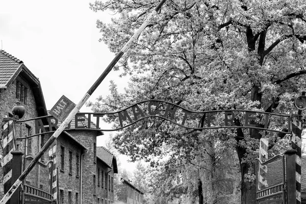 Auschwitz, Poland - August 12, 2017: View of the concentration camp gate with a slogan black and white photo — Stock Photo, Image