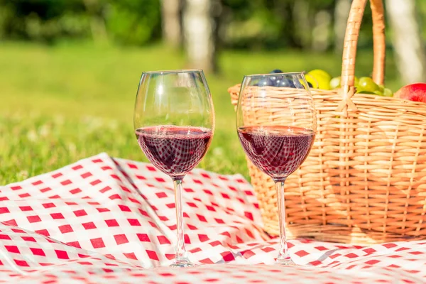 Picnic en el césped objetos - dos copas de vino y una cesta de —  Fotos de Stock