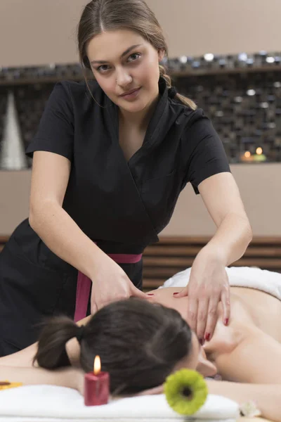 Spa woman. Female enjoying relaxing back massage in cosmetology spa centre. Body care, skin care, wellness, wellbeing, beauty treatment concept.