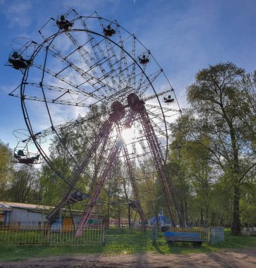 Vologda. Bahar. Gaziler Parkı 'nda terk edilmiş eski araçlar. Ferris ne?