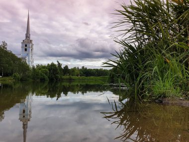 Yaroslavl. Peter and Paul Park and the Church of saints Peter and Paul. 18th century.The oldest Park in Yaroslavl. Pond, reflection of trees clipart