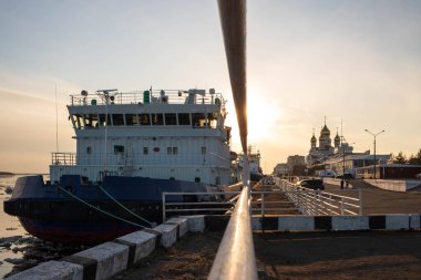 Arkhangelsk. At the pier of the sea station. Icebreakers on the background of the sunset. Ice-drift on the Northern Dvina. Mikhailo-Archangel Cathedral, Orthodoxy clipart