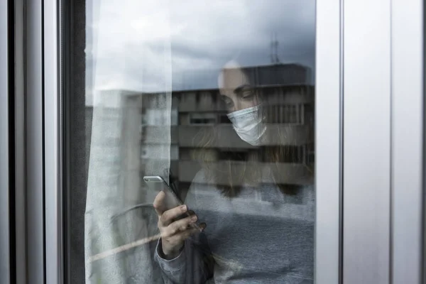 Woman Respirator Chatting Her Smart Phone Looking Window Her House — Stock Photo, Image