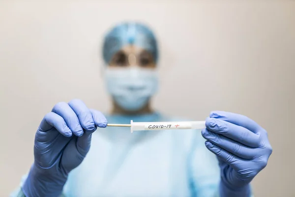 young nurse in protective clothing doing covid-19 test