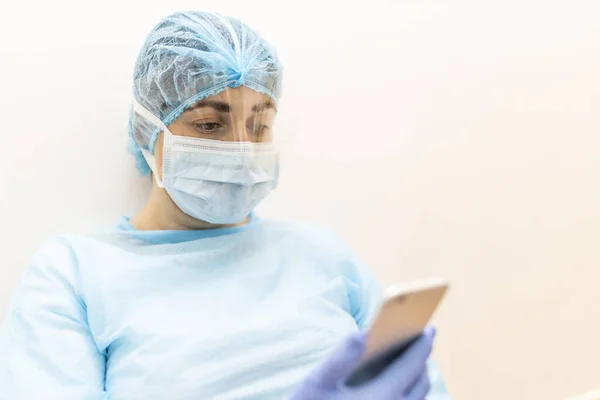 Young Nurse Protective Clothing Resting Hard Shift Checking Messages Her — Stock Photo, Image