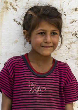 Wakhan, Tajikistan - June 20, 2020: Portrait of a girl in the Wakhan Valley at the Pamir Highway in Tajikistan.