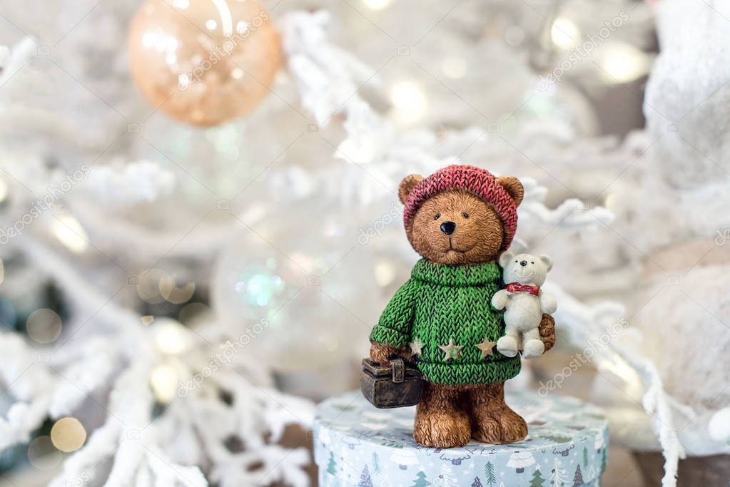 Cute teddy bear with gifts on bokeh background