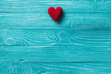 Örgü kalp mavi ahşap arka plan üzerinde