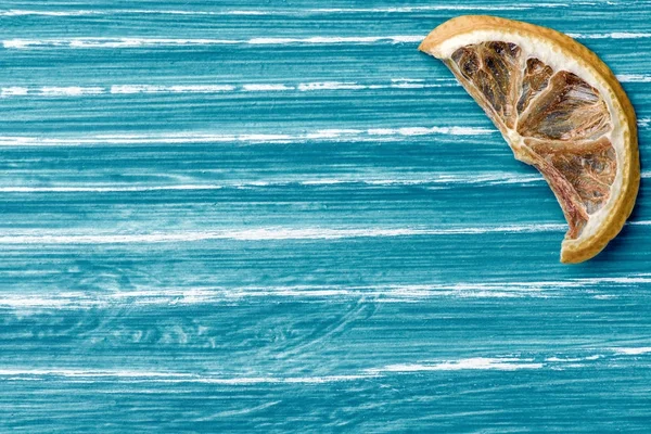 Dried lemon on blue wooden background