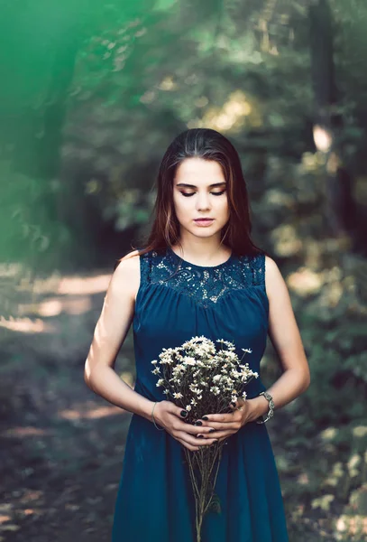 Dziewczyna z kwiatami stokrotki w lesie — Zdjęcie stockowe