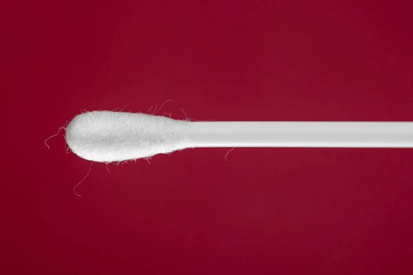 Cotton buds on red background — Stock Photo, Image