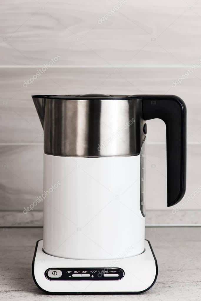 White modern electric kettle in the kitchen