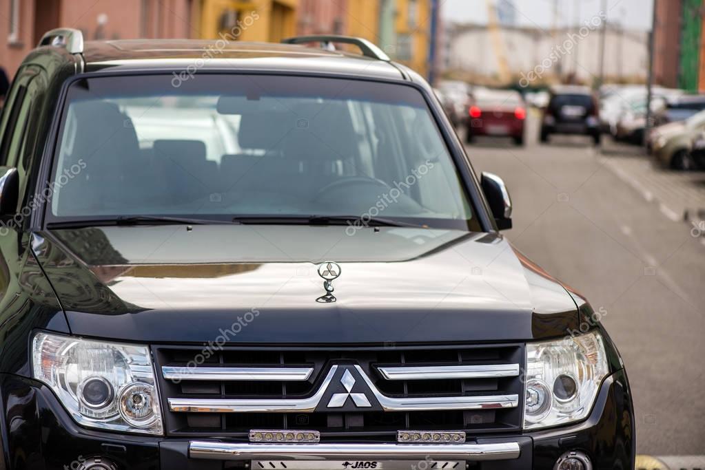 Kyiv, Ukraine - October 23th, 2016: Close up view of new Mitsubishi Pajero IV. The windshield, hood, headlights and logo.
