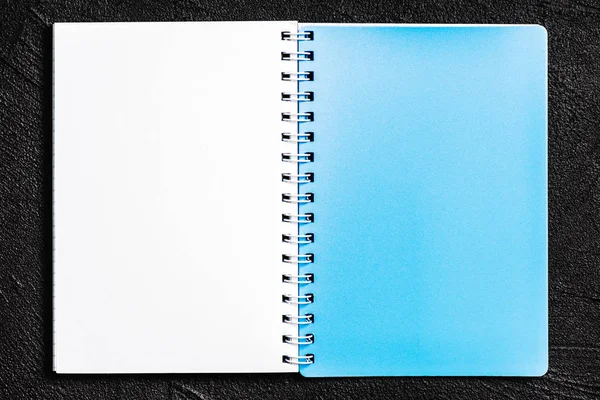 Notepad located on black background — Stock Photo, Image