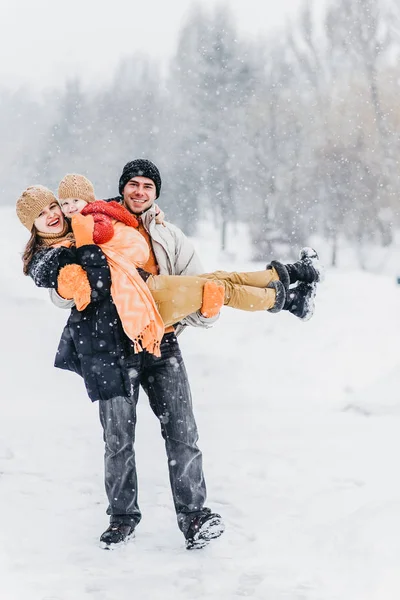 Ładny rodziny grając w parku w zimie — Zdjęcie stockowe