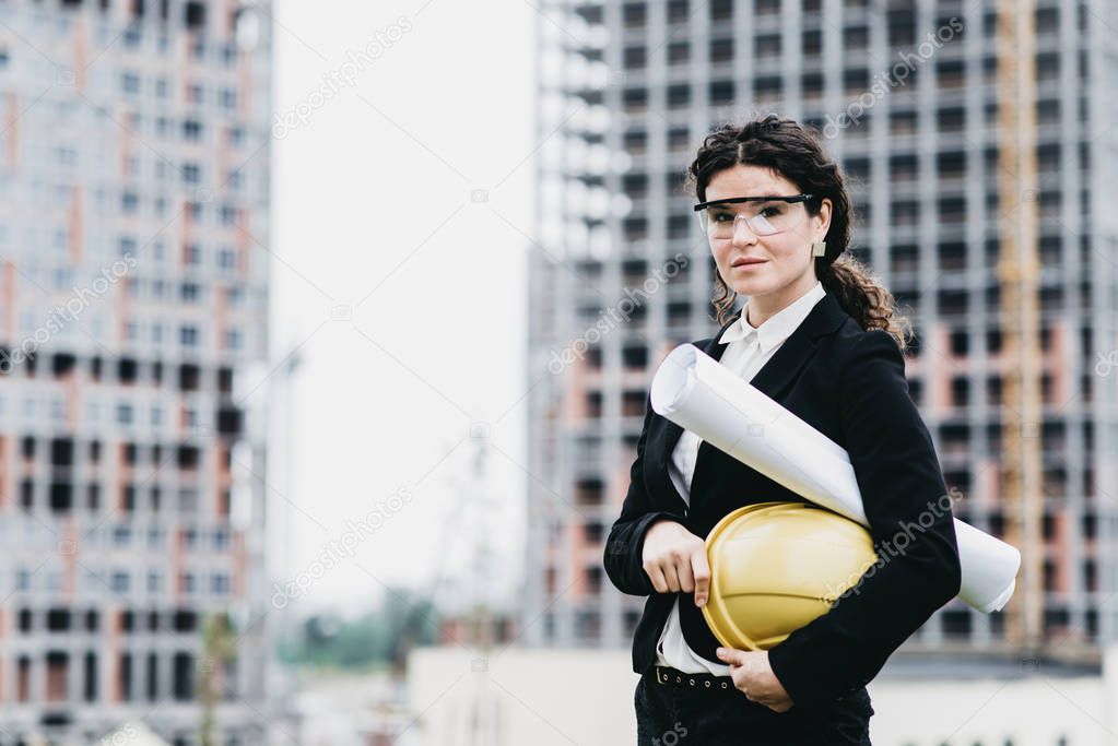 Close up portrait of beautiful girl in a yellow protective helme