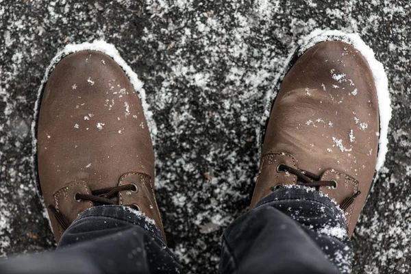 Brown boots covered with snowflakes, top view — Stock Photo, Image