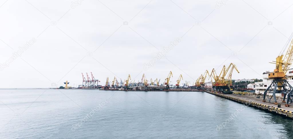 Sea port with cranes and docks early in the morning