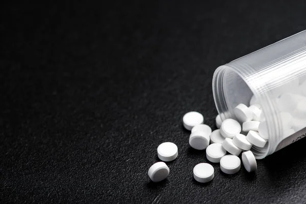 stock image Medical white pills for the treatment and health care on a black background. 