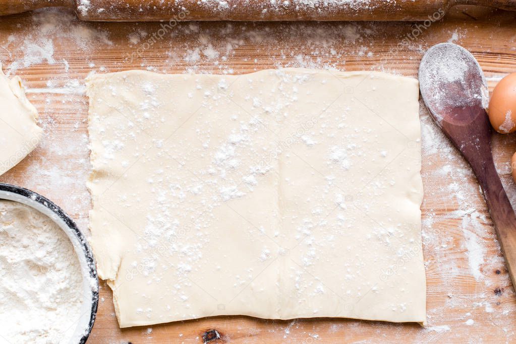 Ingredients for cooking baking - flour, dough on wooden background 