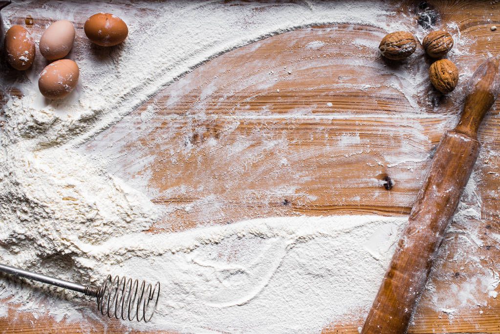 Ingredients for cooking baking - flour, dough on wooden background