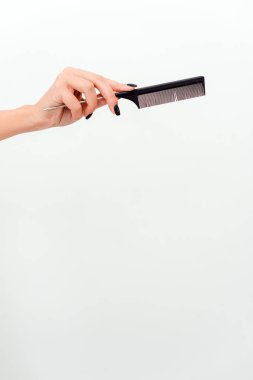 Woman hands with hair comb isolated on a white background