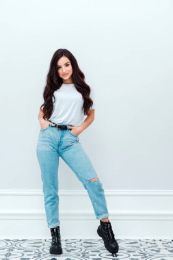 Pretty, slim girl posing on a white background. Copy space