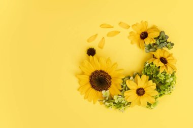 bouquet of fresh flowers on a yellow background.- Copy space