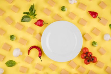 Ingredients for cooking arranged on a yellow background. Concept of italian cuisine
