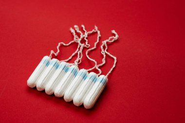 Tampons isolated on red background. Concept women sanitary prote clipart