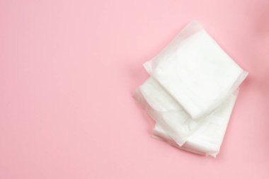 Woman pads lying on  pink  background. Woman hygiene protection 