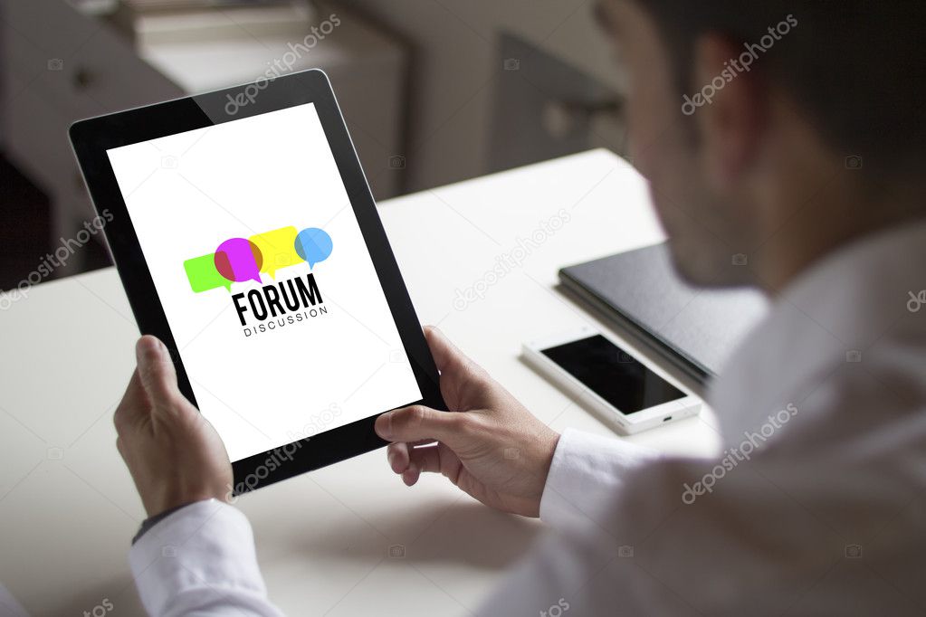 businessman holding tablet pc with forum