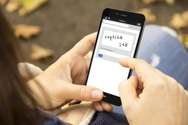 Woman holding a 3d generated smartphone with captcha on the screen — Stock Photo, Image