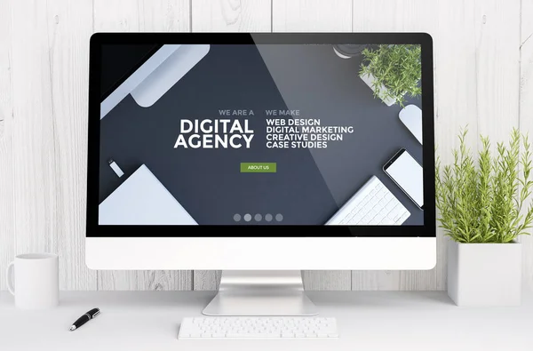 monitor with agency website design on screen