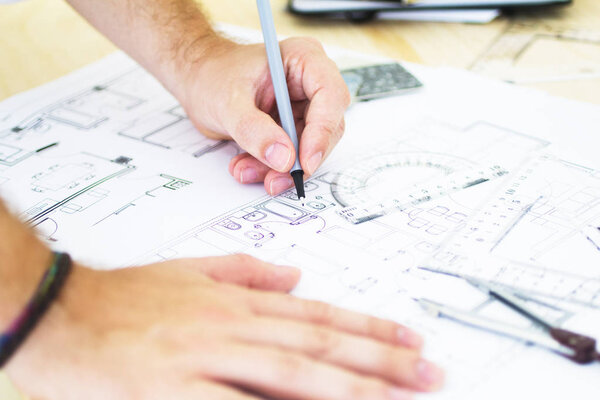 architect drawing blueprints