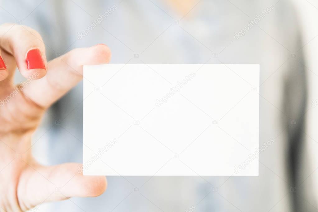 woman holding white blank business card mockup