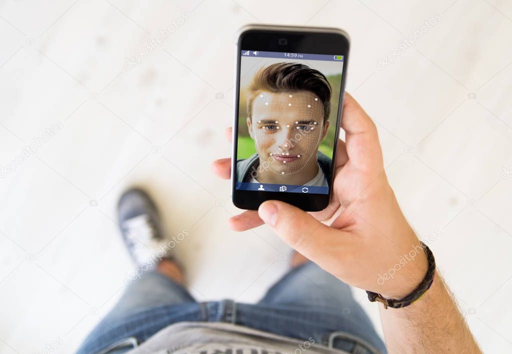 man touching screen of smartphone to use facial recognition