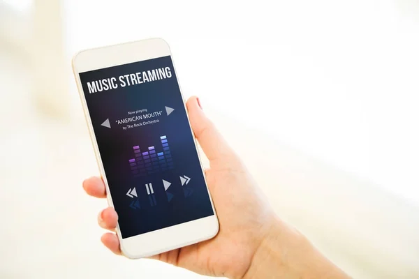 Female Hand Holding Smartphone Showing Music Streaming Interface — Stock Photo, Image