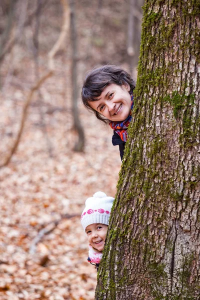 Mother and daughter playing in the forest — Stock Photo, Image