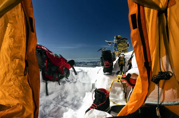The climbing gear and view out of a tent