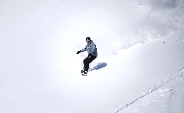 Man snowboarding in the mountains