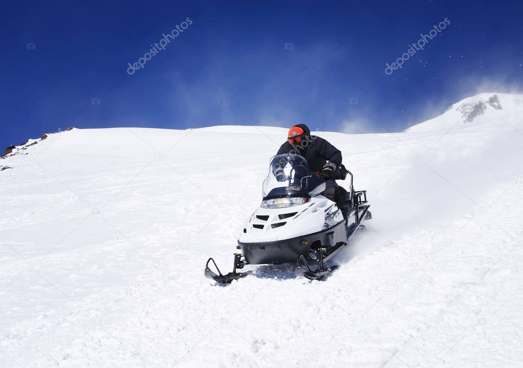 Man on a snowmobile in the mountains