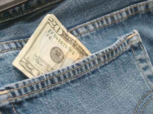a pair of jeans with money in pocket.