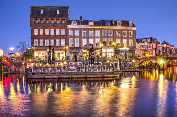 Leiden, The Netherlands, February 24, 2018: Evening view of the convergence of the Old and New Rhine