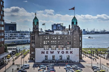 Rotterdam, The Netherlands, June 17, 2017: View of Hotel New York, former office of the Holland America Line, on Wilhelminapier where many emigrants left for the USA clipart