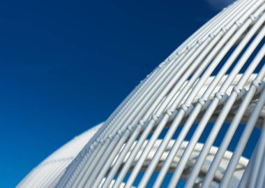 Beyaz kapüşonlu plaj sandalyesi, çizgili bir arka plan gibi görünüyor.