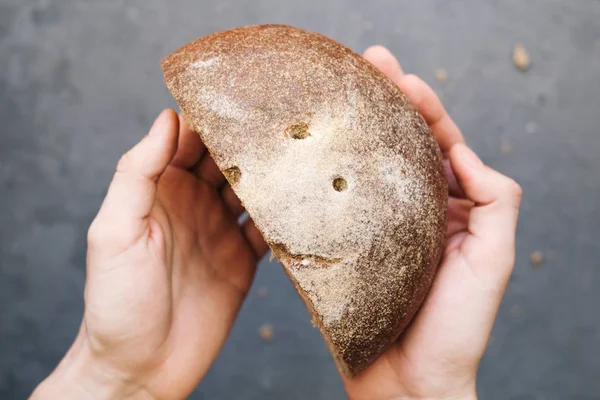 warm, freshly rye bread. Cut the slices. Tear off a piece. top view. Farm food made from flour and eggs.