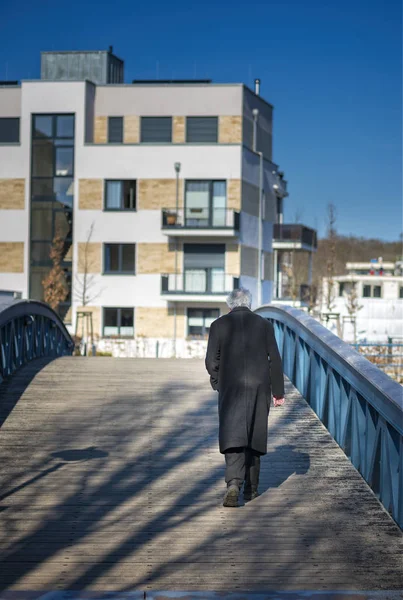Old man walking Over The Bridge